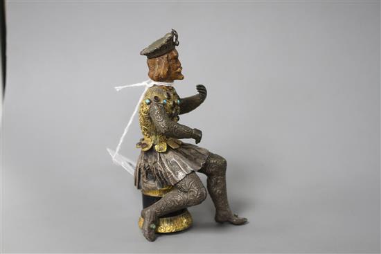 An Austro-Hungarian gilt and white metal figure of a seated knight, with jewelled decoration and hardwood head, height 11.5cm